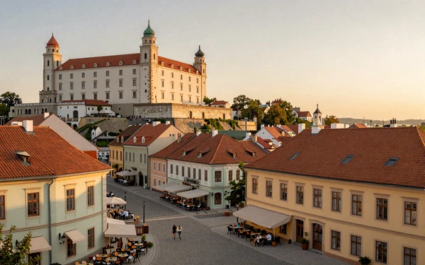 Bratislava old town at golden hour with Bratislava Castle overlooking Baroque streets perfect for romantic dates